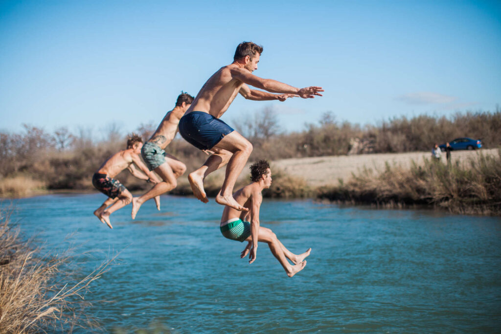 cliff jumping into the crystal clear llano river